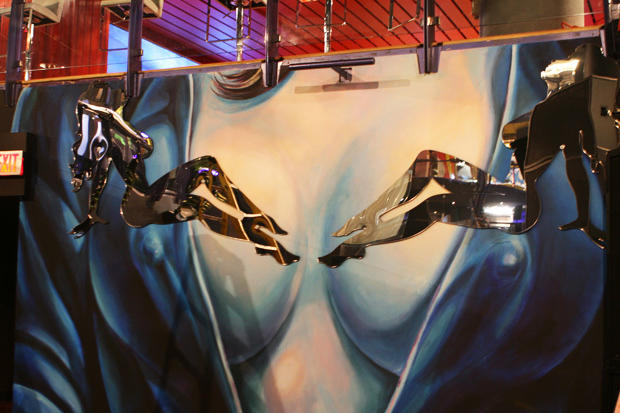 Full view of decorative laser cut acrylic mud flap girls wall mounted to painted female torso mural in night club - Circa Toronto