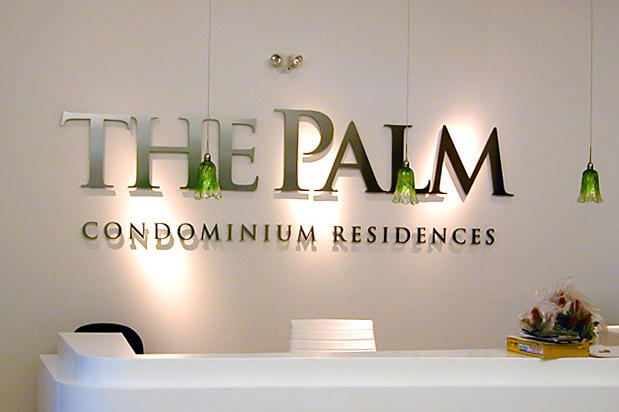 The Palm corporate condo sales office lobby signage made with 3d metal sign lettering installed in reception area and made by Art Signs