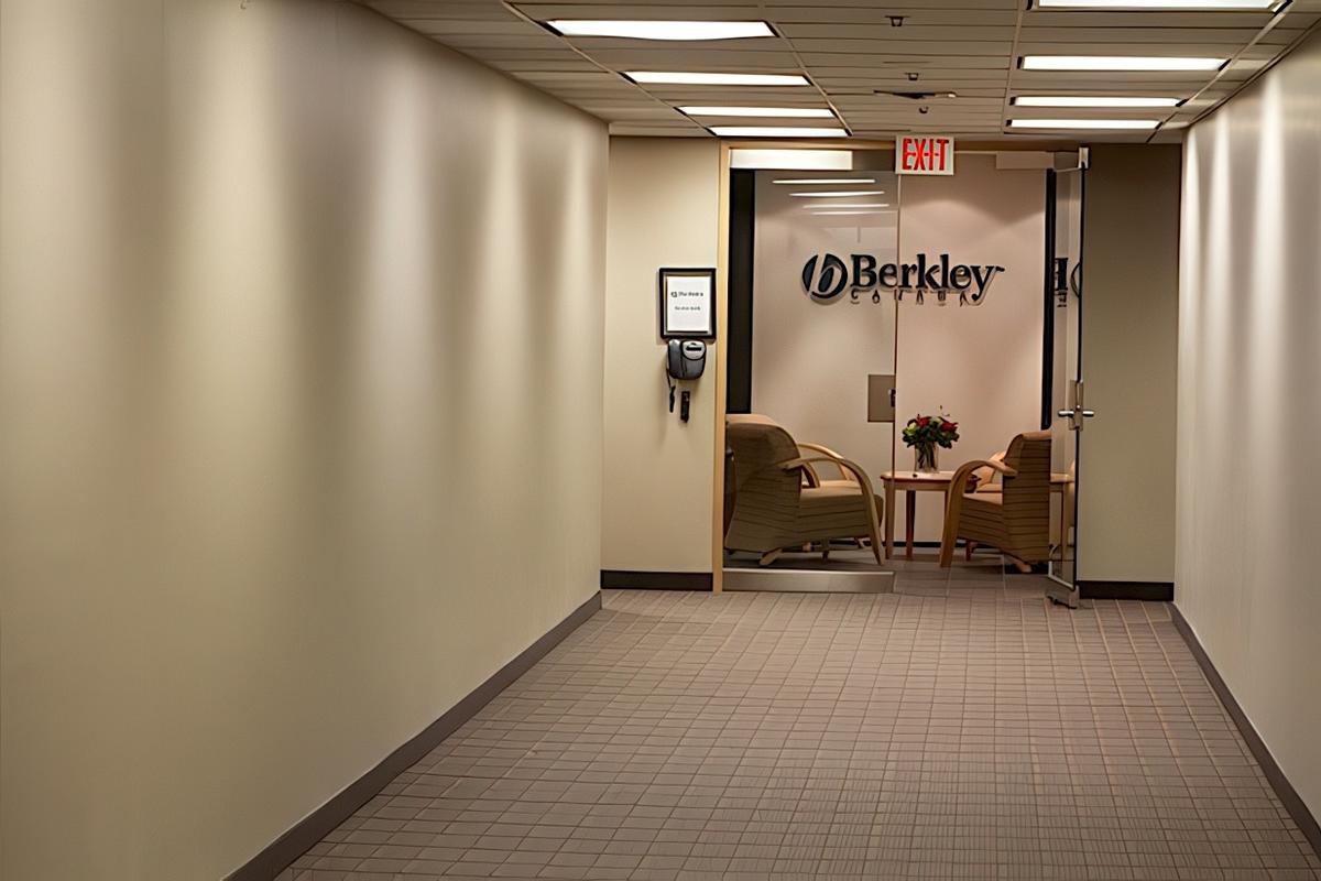 Distance view project by artsigns corp, Custom 3D acrylic office signage with custom-matched dark grey painted letters installed at the end of a corporate hallway, creating a refined professional first impression.