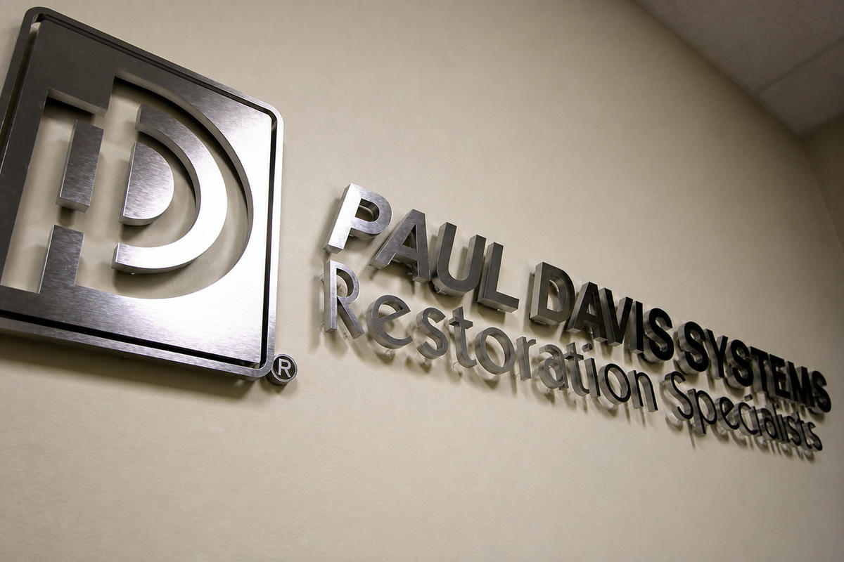Angled Paul Davis dimensional reception sign with brushed nickel faces and wall spacers