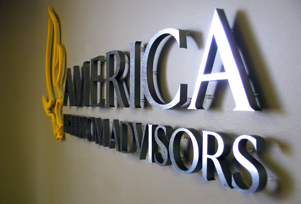 Corporate logo sign with brushed metal finish to match stainless steel look, waiting area wall installation