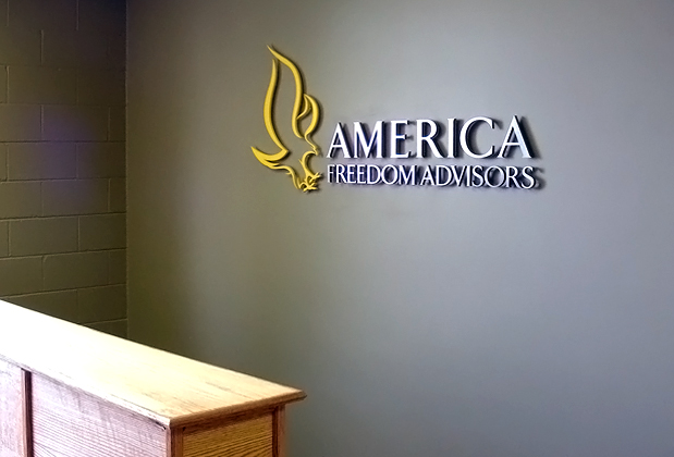 Corporate logo sign with brushed metal finish to match stainless steel look, waiting area wall installation