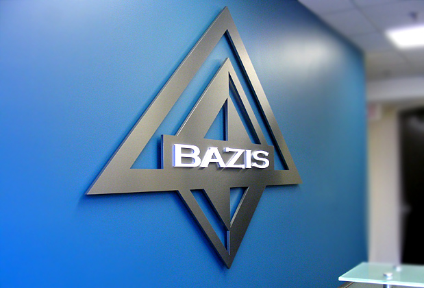 Corporate logo sign with brushed metal finish to match stainless steel look, waiting area wall installation