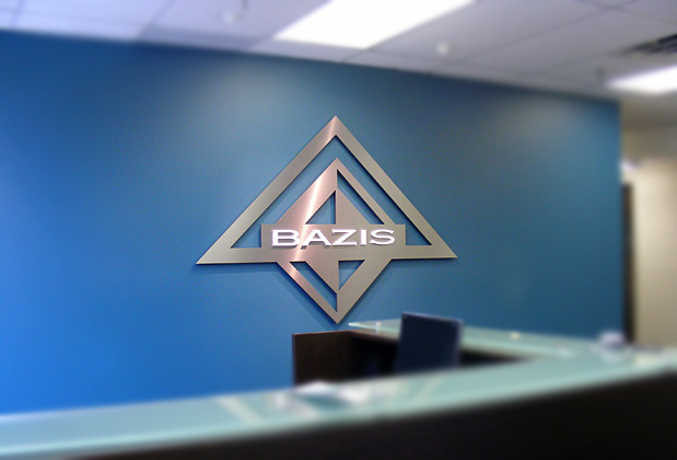 Corporate logo sign with brushed metal finish to match stainless steel look, waiting area wall installation
