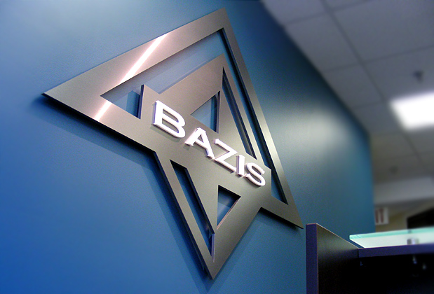 Corporate logo sign with brushed metal finish to match stainless steel look, waiting area wall installation